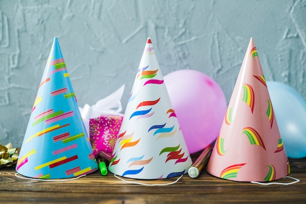 Party hats and balloons on table
