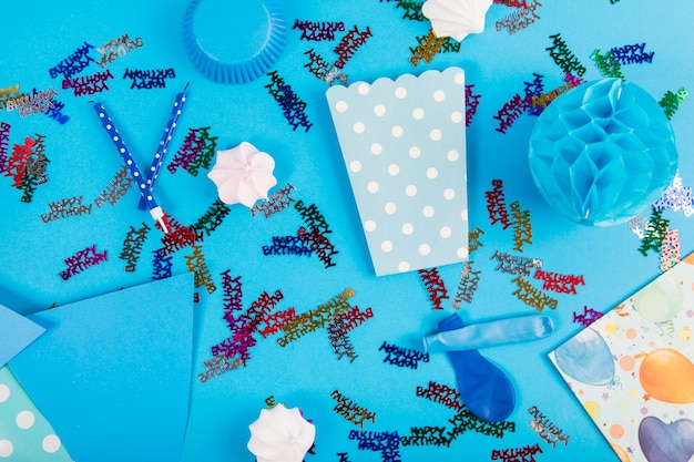 Party items and zephyrs on blue background