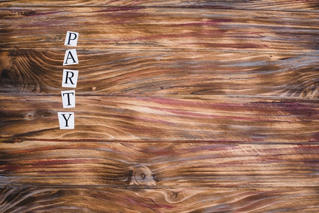 Free photo party word on wooden surface