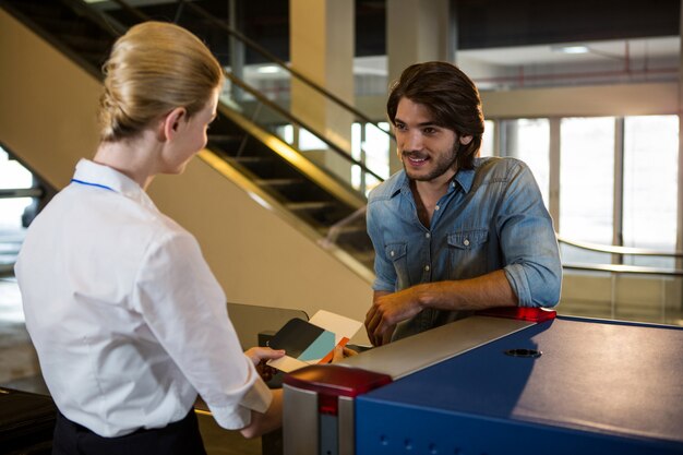 Passenger having a conversation with female staff