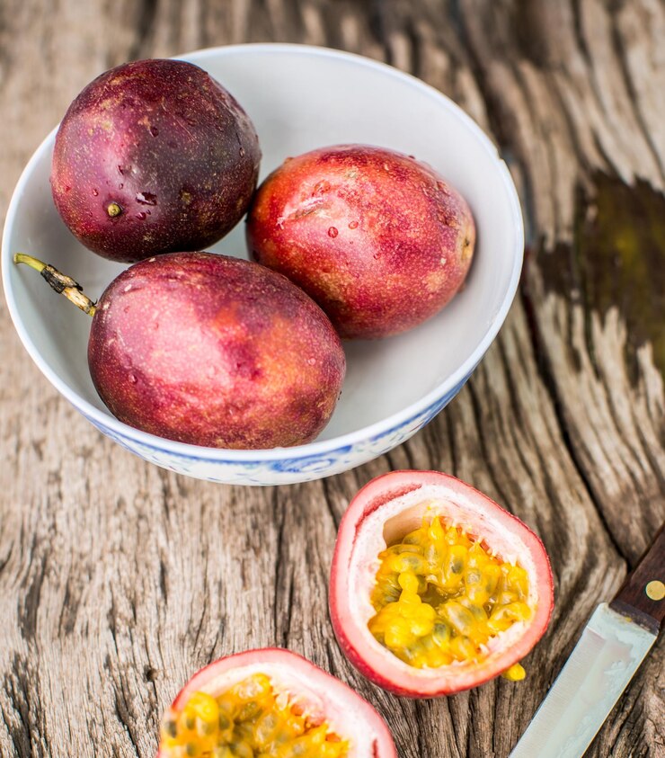Free Photo passion fruit on a wooden board with knife