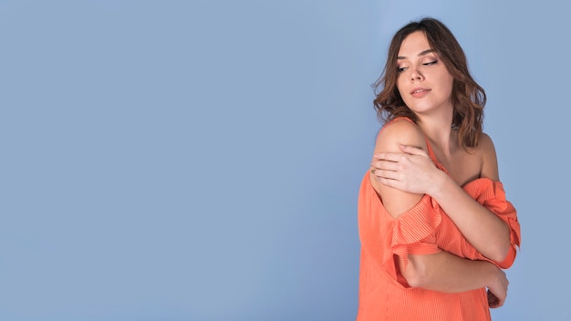 Free photo passionate attractive lady in orange blouse