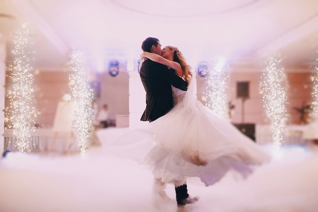 Passionate newlyweds dancing