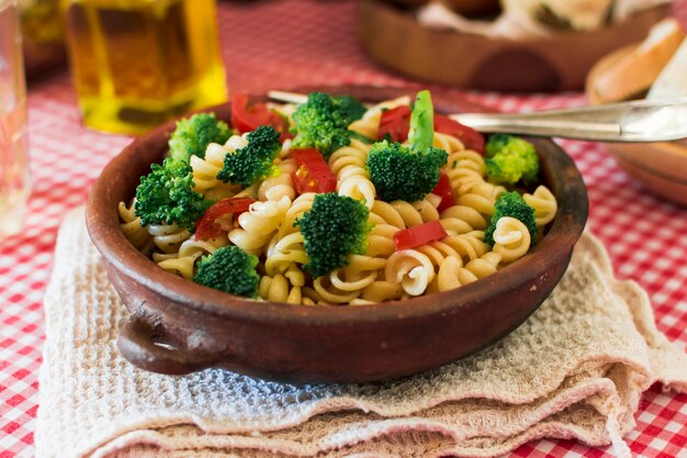 Pasta fusilli with tomato and broccoli in the earthenware