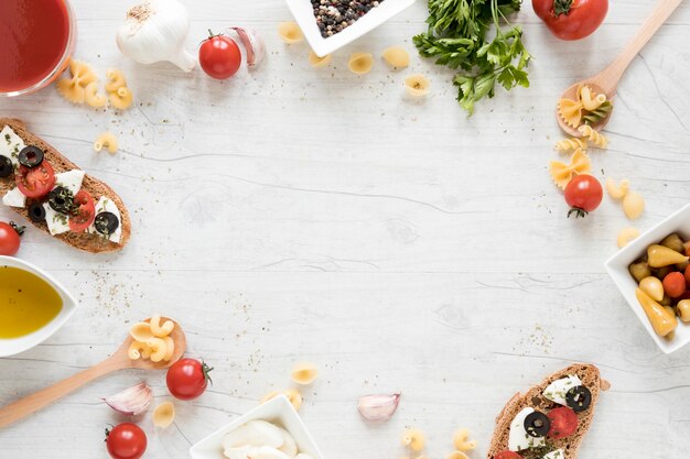 Pasta ingredient arranged in circular frame on wooden desk