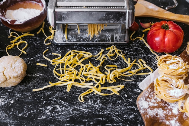 Pasta and ingredients near machine