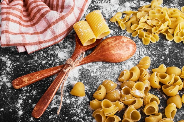 Pasta isolated on black covered with flour.