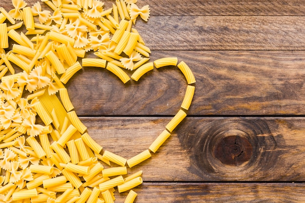 Free photo pasta lying near heart