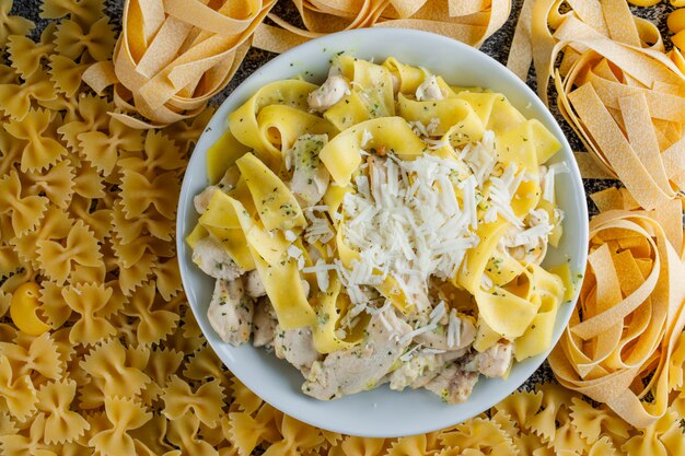 Pasta meal in a plate on a raw pasta