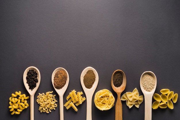 Pasta near spoons with spices