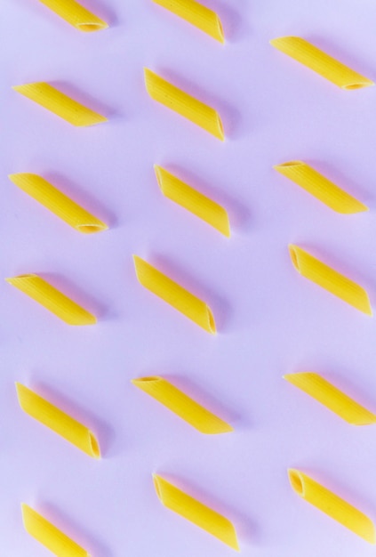 Free photo pasta in a pattern on a colorful paper