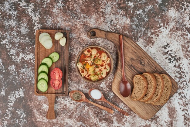 Pasta soup in tomato sauce with vegetable salad.