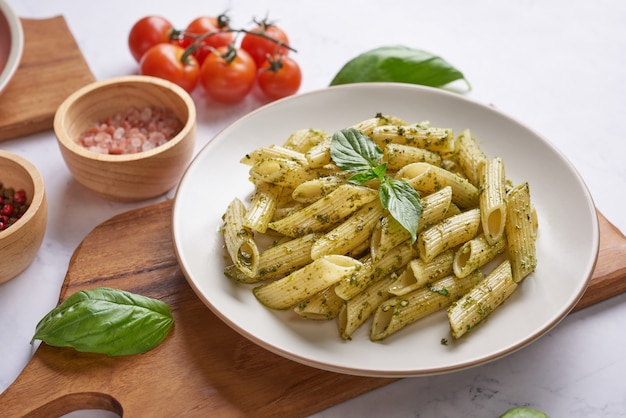 Pasta spaghetti with zucchini, basil, cream and cheese on stone table.