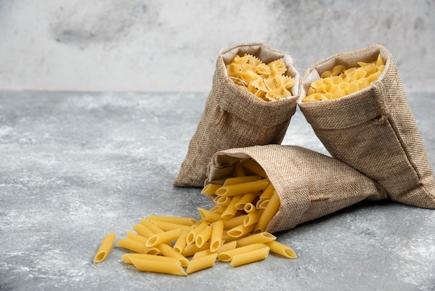 Pasta varieties inside rustic baskets.