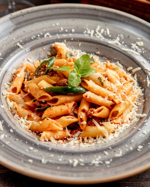 Pasta with meat grated cheese and basil leaf