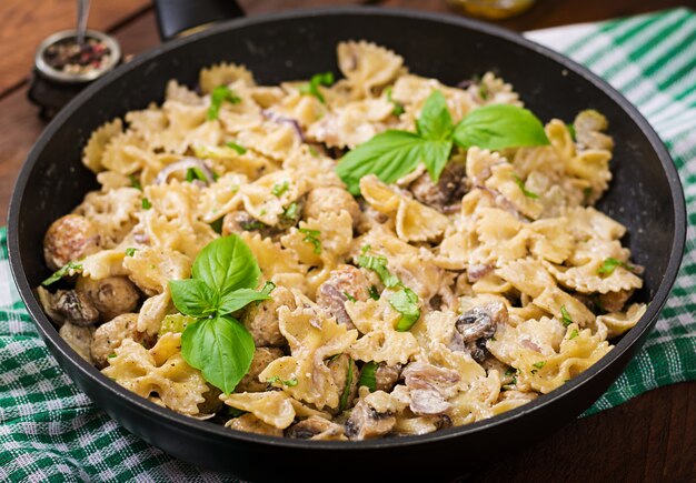 Pasta with meatballs and mushrooms in creamy sauce