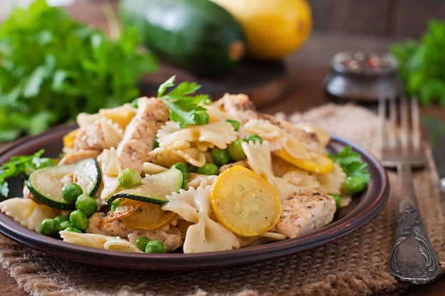 Pasta with zucchini, chicken and green peas