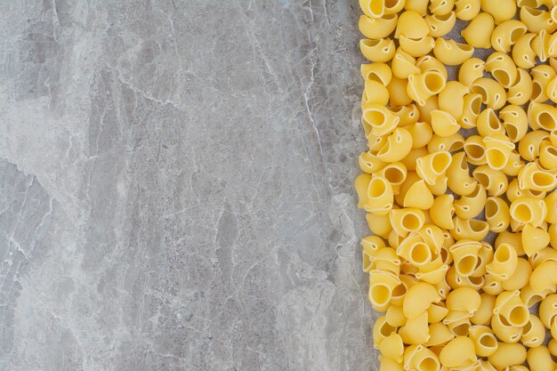 Pastas spread over the grey marble surface