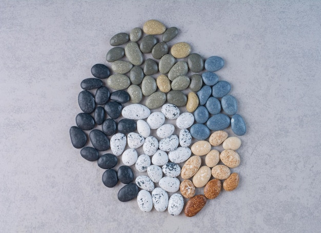 Free photo pastel color stones for crafting on concrete surface.