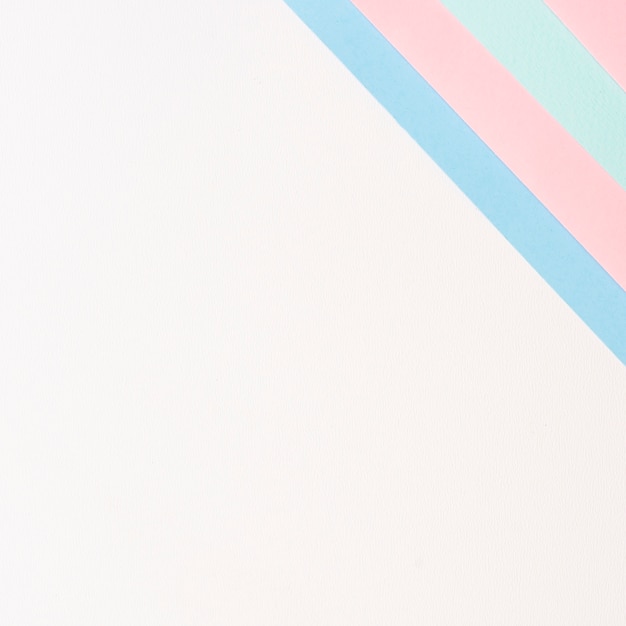 Free photo pastel colors aligned paper sheets