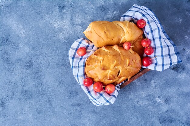 Pastry buns on a checked towel on blue