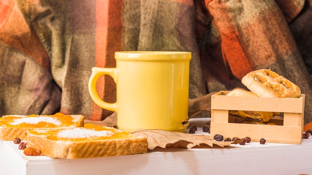 Pastry and mug near drapery