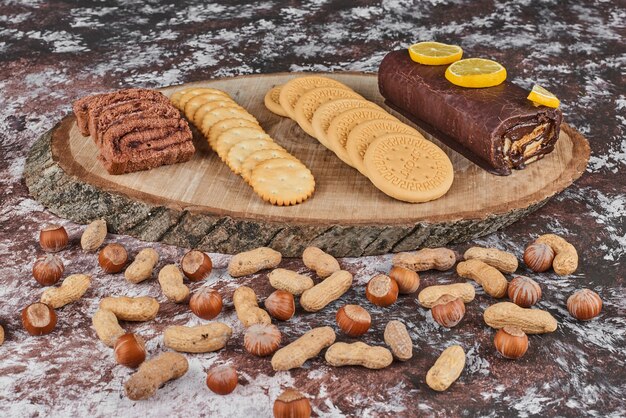 Free photo pastry and nuts on a wooden board.