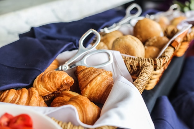 Pastry in the wicker basket croissant buns side view