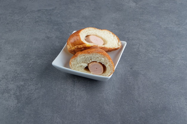 Pastry with sausages sliced into two pieces. 