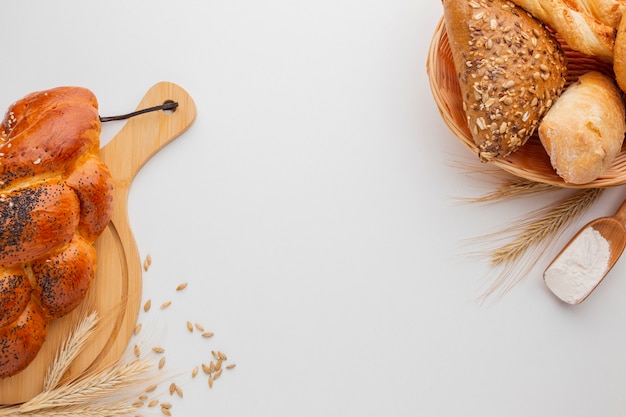 Pastry on wooden board and basket of bread