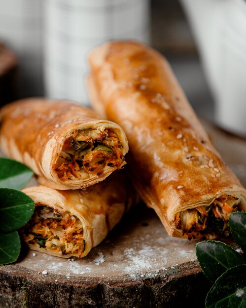 Pastry wrap filled with carrot bell peppers chicken and herbs