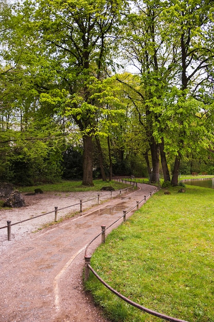 Path through park with green trees