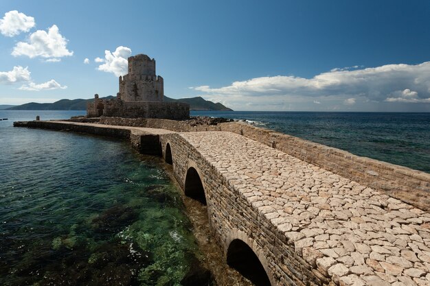 Pathway towards the Methoni Venetian Fortress under a blue sky in Greece