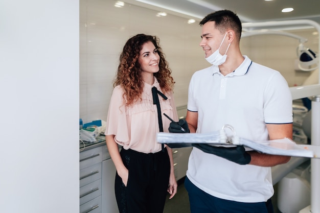 Patient and dentist looking at each other in the office