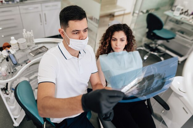 Patient and dentist looking at radiography