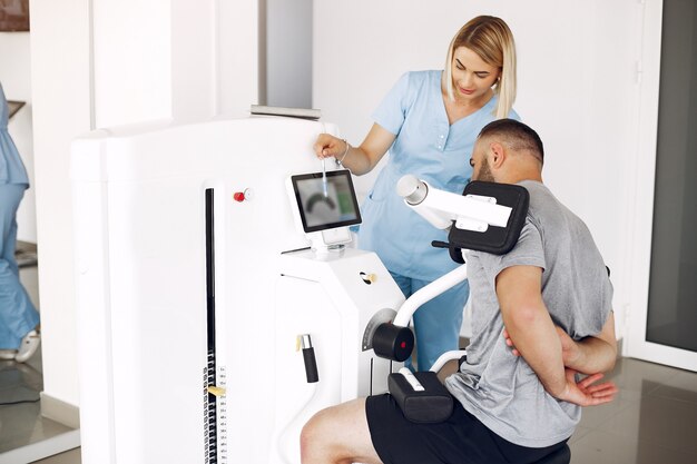 Patient doing exercise using sports equipment with therapist