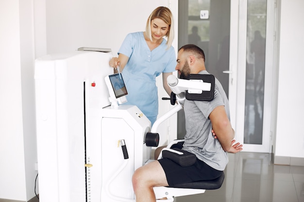 Patient doing exercise using sports equipment with therapist