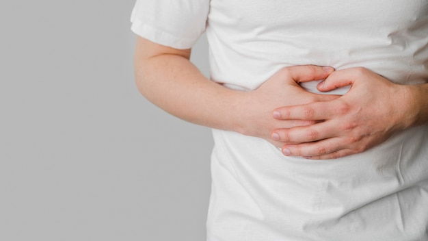 Premium Photo | A woman with a stomachache showing stomachache by facial expressions