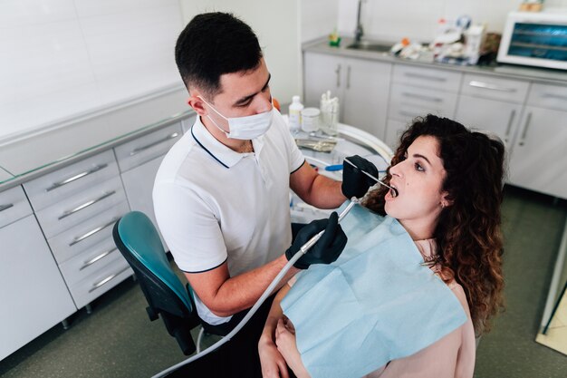 Patient getting teeth cleaning at the dentist