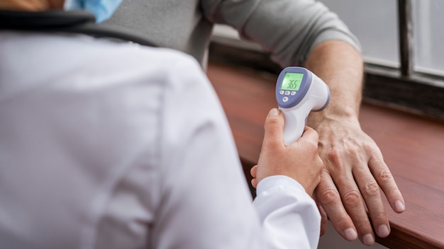 Patient having his temperature checked