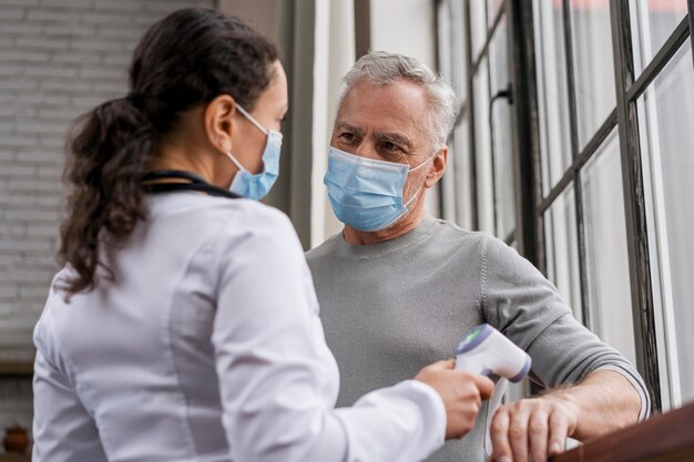 Patient having his temperature checked