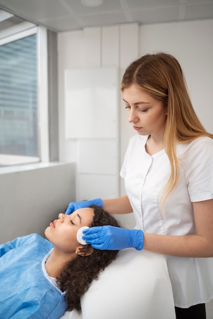 Patient undergoing microneedling procedure