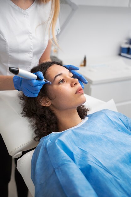 Patient undergoing microneedling procedure