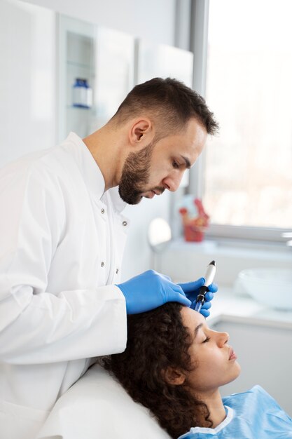 Patient undergoing microneedling procedure