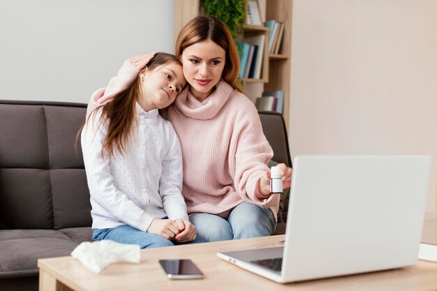 Patients consulting doctor with laptop