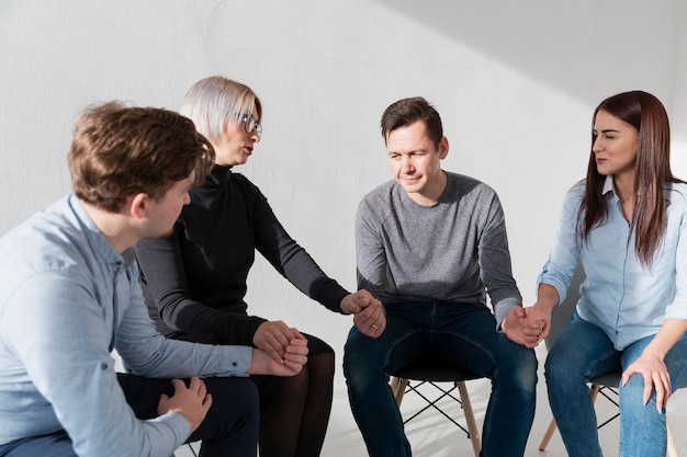 Patients holding hands and telling their problems