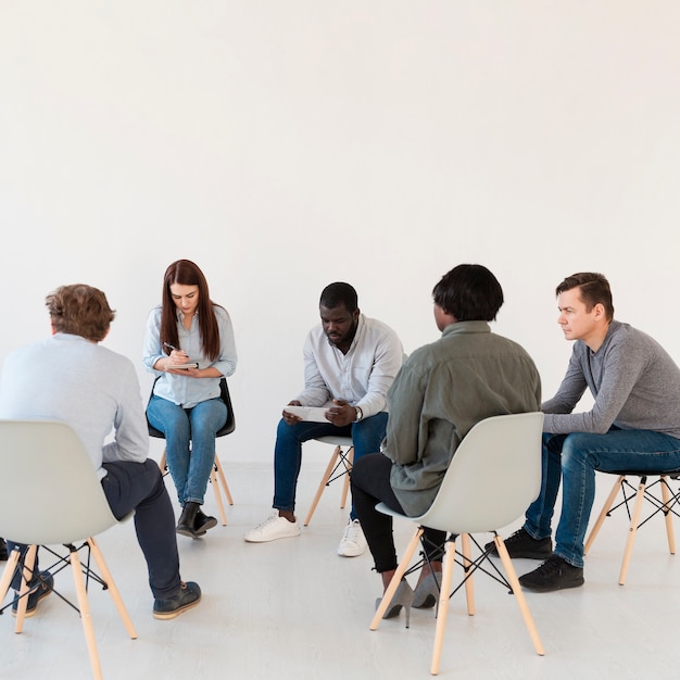 Free photo patients standing in circle and reading