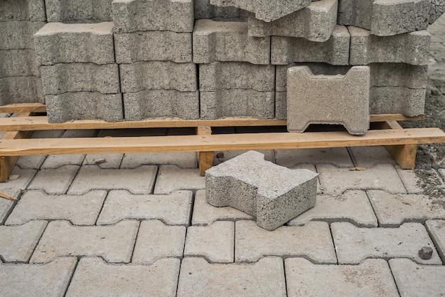 Paving slabs stacked on a pallet road repair process closeup selective focus on tiles seasonal reconstruction of pavement in walking paths in parks