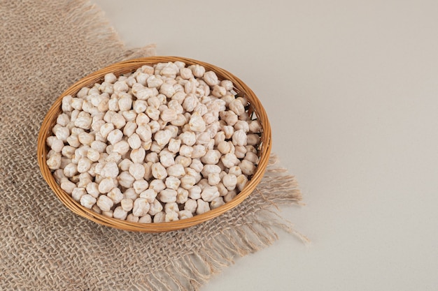 Pea beans in a food tray on concrete.