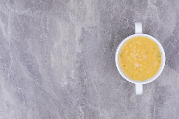 Pea beans soup in a white bowl on the grey surface